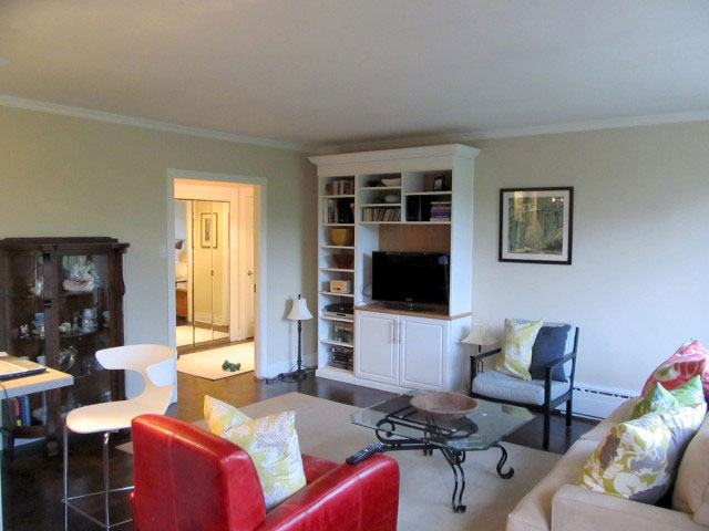 a living room filled with furniture and a flat screen tv